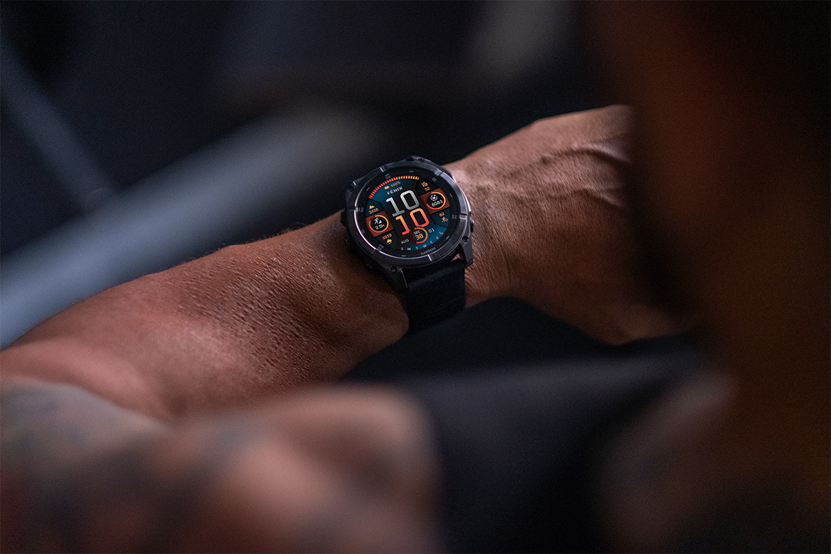 A fēnix 8 GPS smartwatch on a man's wrist displays the time of 10:10.