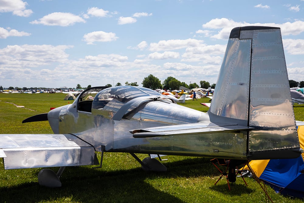 Airplane parked in a field with other aircraft at EAA AirVenture Oshkosh 2019