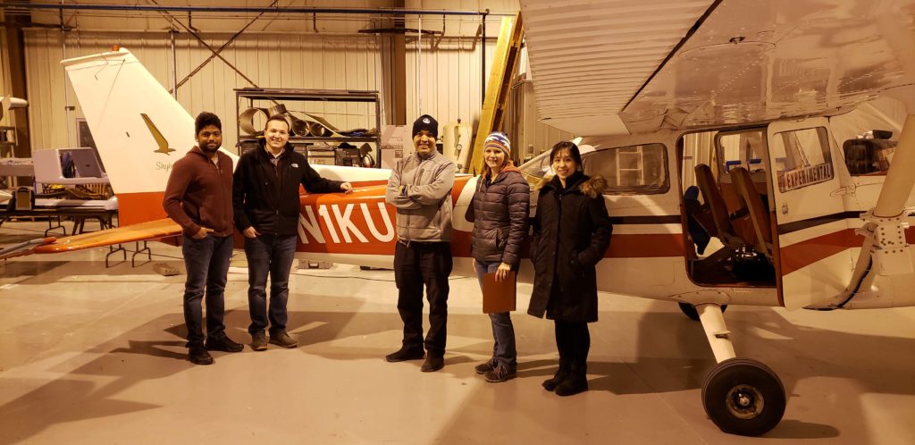 Students stand in front of the specially equipped Cessna 172