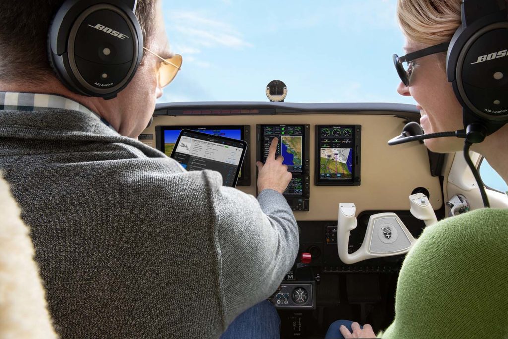 Pilot and passenger in cockpit interacting with GTN 750 Xi