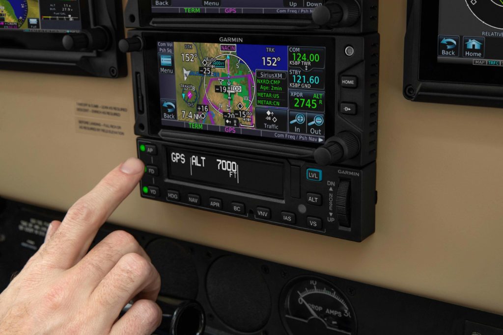 Pilot hand touching GFC 600 autopilot controller