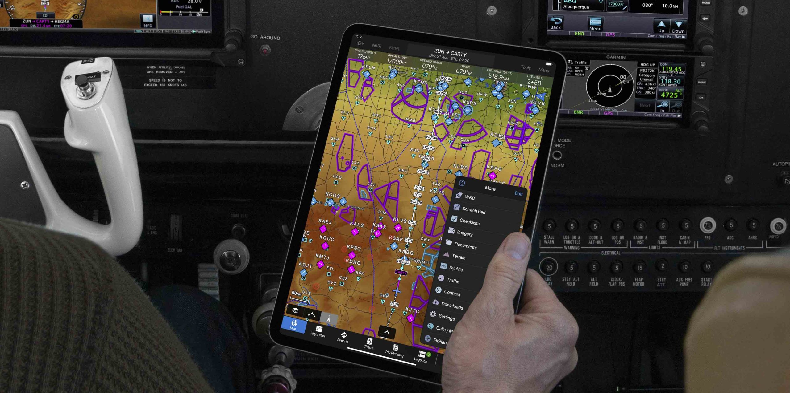 Pilot holding iPad featuring Garmin Pilot app with tab bar menu featured