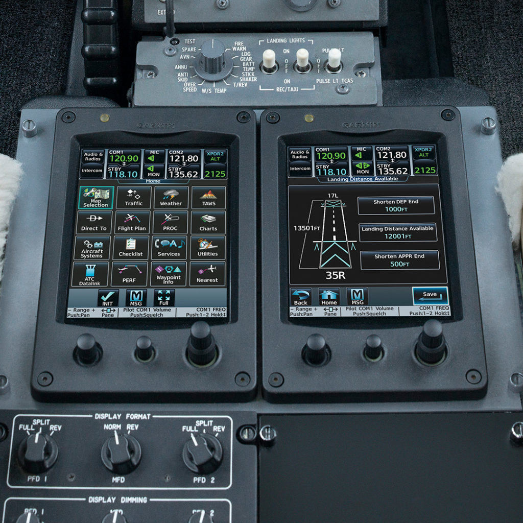 Touchscreen controllers on Garmin G5000 flight deck featuring Takeoff and Landing Data