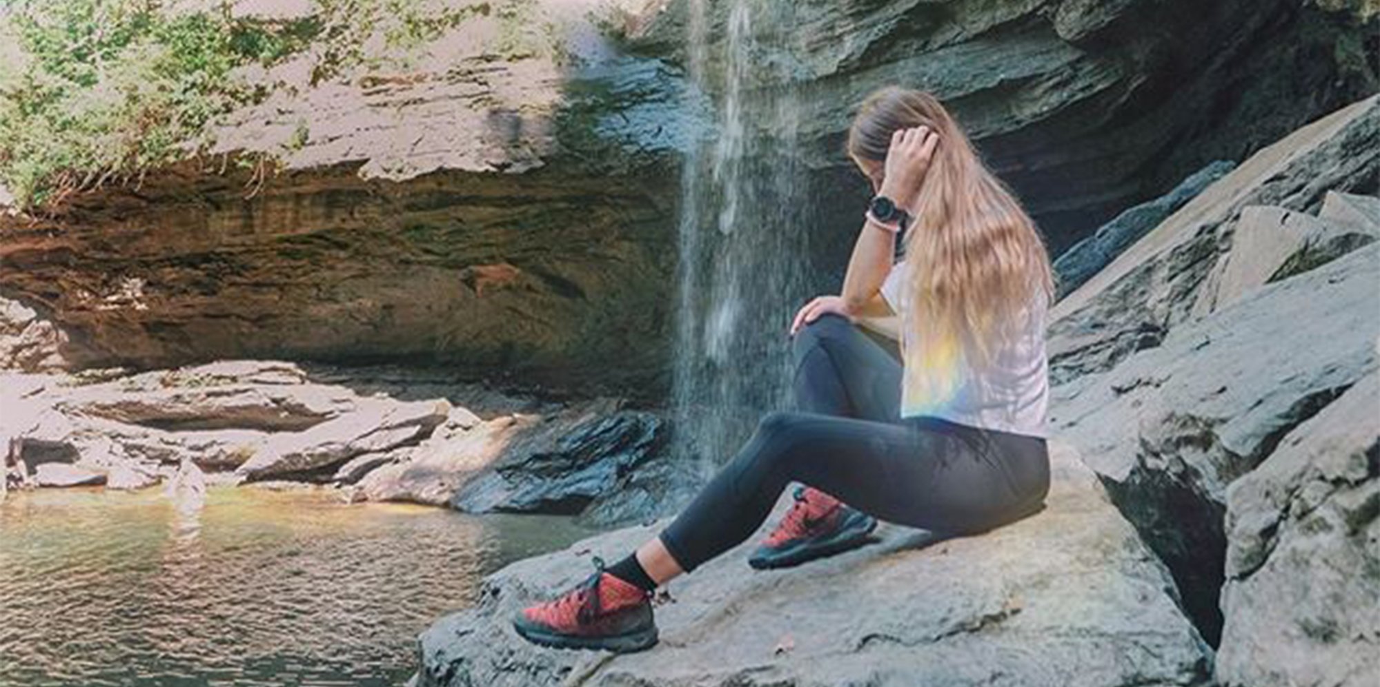 Girl by waterfall