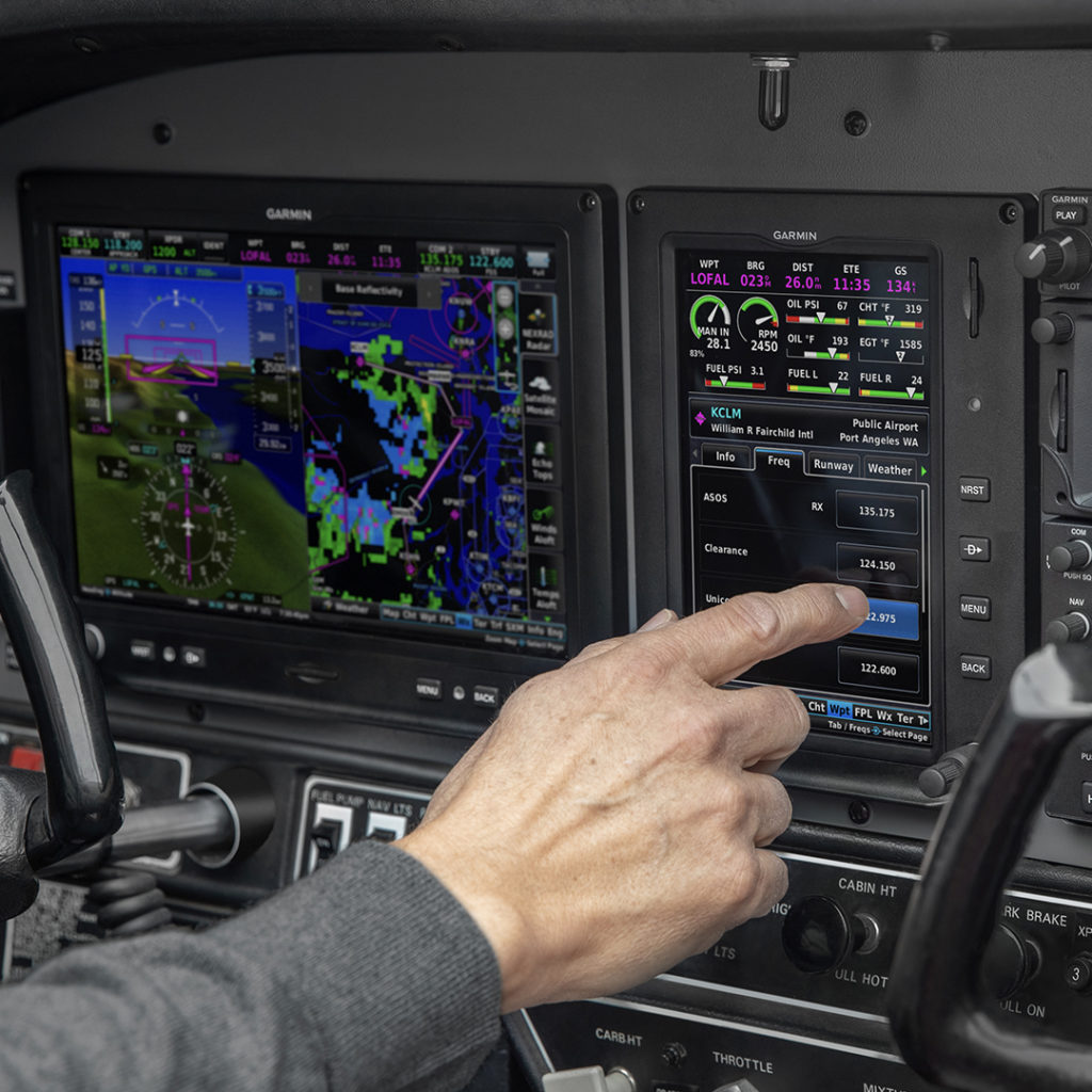Pilot interacting with G3X Touch flight display