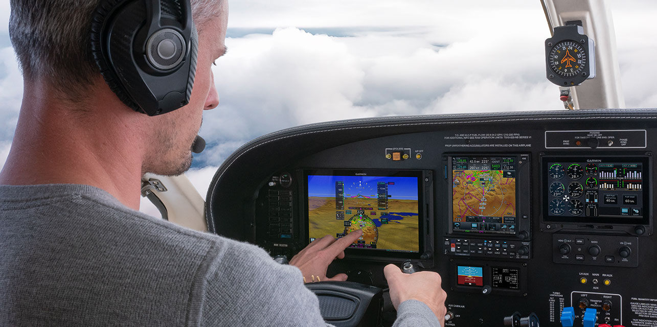 Pilot interacting with HSI map on TXi flight display in cockpit