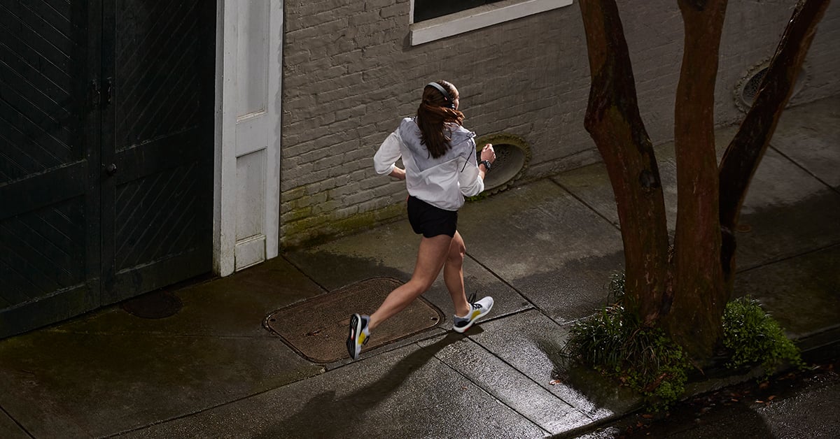 A woman runs with her Garmin smartwatch for safety features