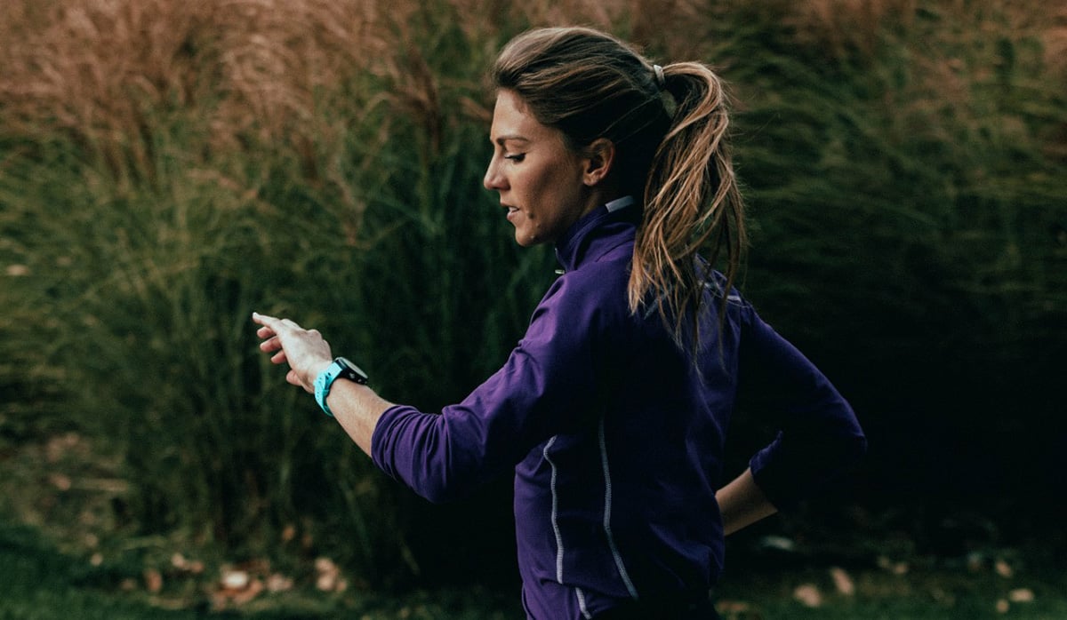 Woman checking her resting heartrate on Garmin smartwatch.